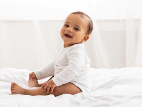 A baby smiling after being in potty training