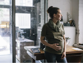 A pregnant woman remembering first trimester anxiety