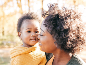 A mother holding her baby to manage newborn hiccups