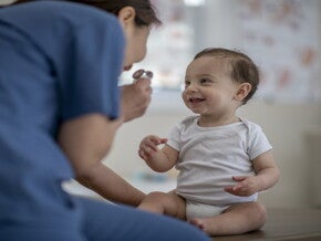 It is important to check in with your pediatrician after discovering allergies and intolerances A doctor checks a baby for allergies and intolerances.
