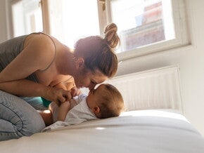 Stimulating speech is essential for your baby first words A mother encouraging her baby's first words through playtime