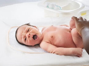 Baby being changed by his mother