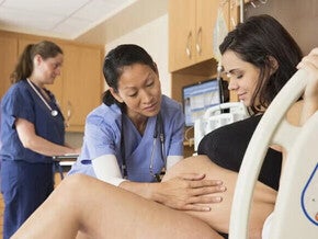 Pregnant women being examined by a female doctor