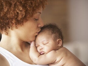 A mother kissing her baby without cradle cap