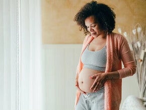 Pregnant women touching her belly with love