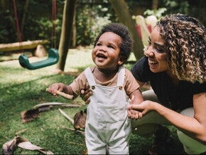 Toddler playing happily after receiving a leg massage for growing pains