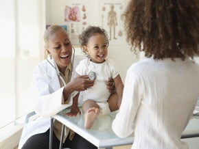 A baby being examined by a pediatrician