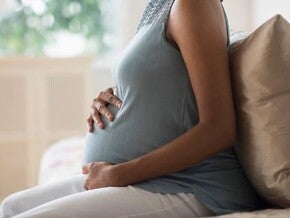 Pregnant woman touching her belly
