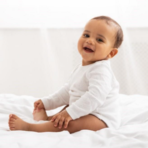 A baby smiling after being in potty training