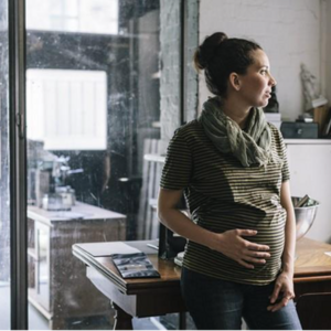 A pregnant woman remembering first trimester anxiety