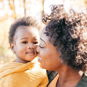 A mother holding her baby to manage newborn hiccups