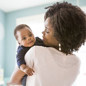 A mother showing  how to stop hiccups in newborns 