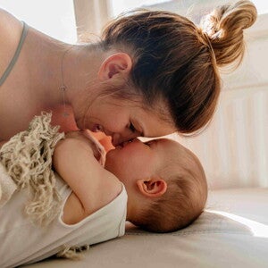 A mom and her child bonding after a baby massage.