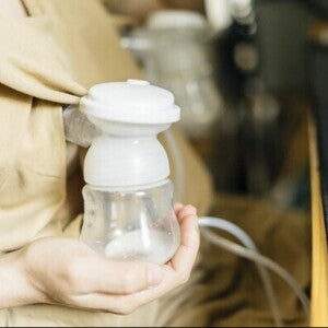 A mother using her electric breast pump 