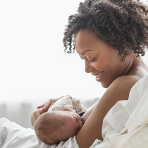 A mother feeding her son and preparing for breastfeed milk storage.