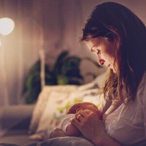 A mother feeding her child without any breastfeeding problems.