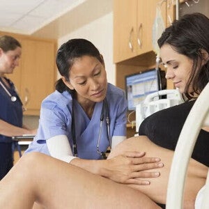 Pregnant women being examined by a female doctor