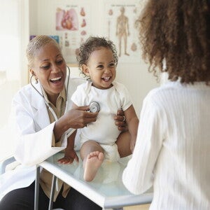 A baby being examined by a pediatrician