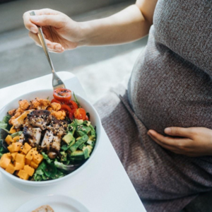 A pregnant woman eating and getting vitamin a in prenatal care
