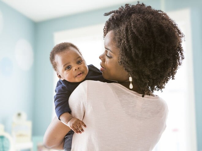 A mother showing  how to stop hiccups in newborns