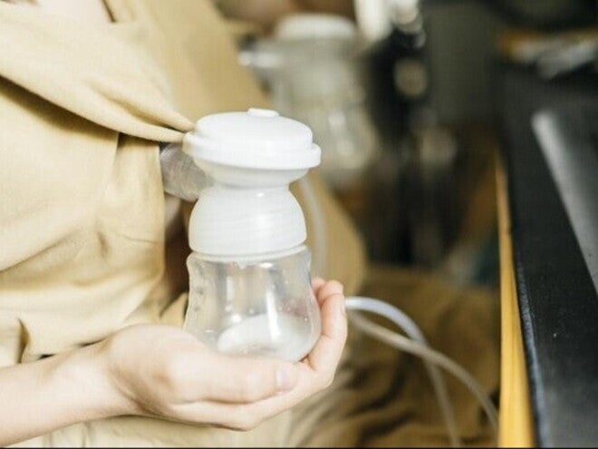A mother using her electric breast pump 