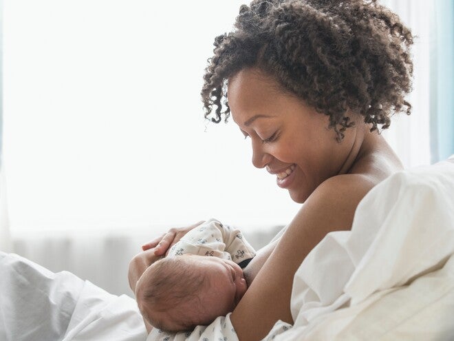 A mother feeding her son and preparing for breastfeed milk storage.