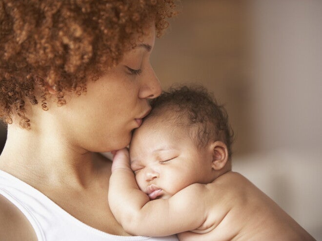 A mother kissing her baby without cradle cap