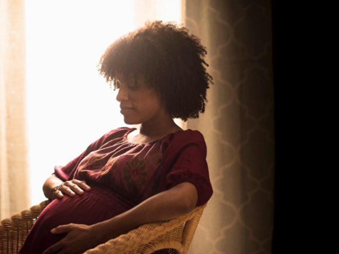 A mother with her newborn after an episiotomy.