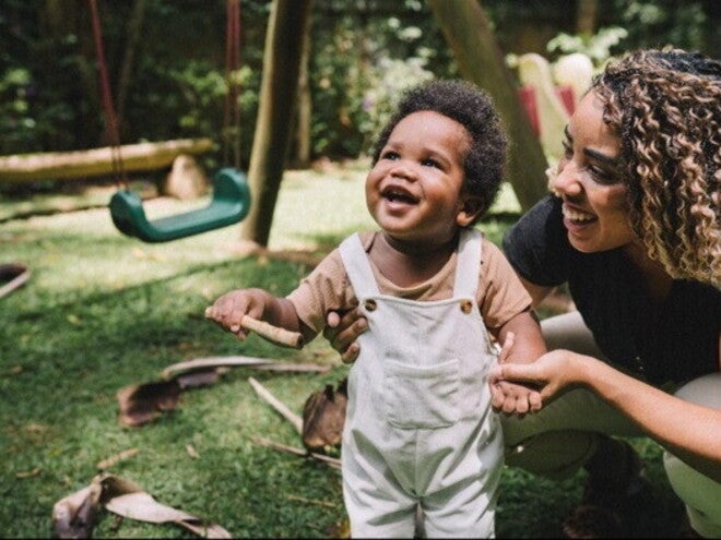 Toddler playing happily after receiving a leg massage for growing pains