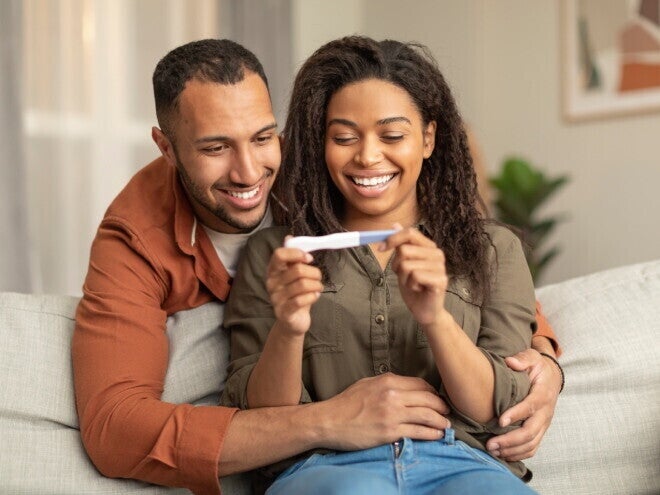 A couple watching a pregnancy test after an ovulation test.