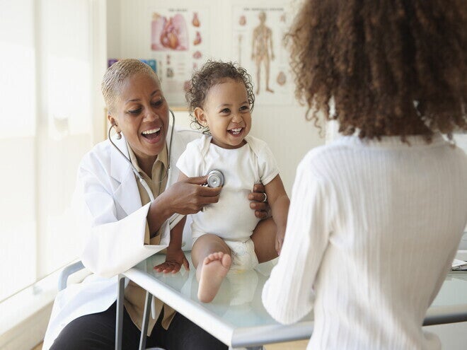 A baby being examined by a pediatrician