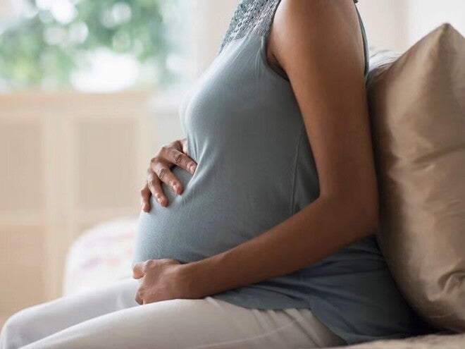 Pregnant woman touching her belly