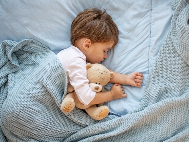 Learn more about how to deal with your toddler sleep problems. A child sleeping without any toddler sleep problems.
