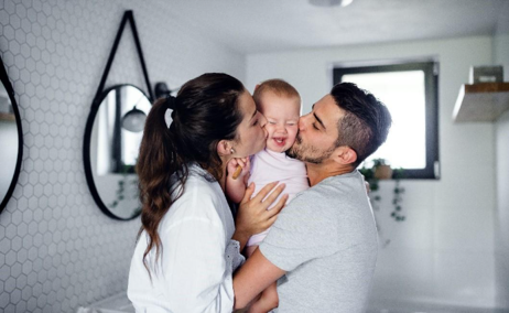 A toddler and her parents celebrating after potty training