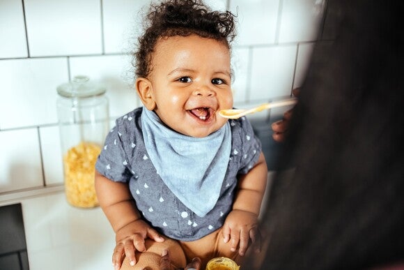 A Baby being fed slowly to prevent  hiccups