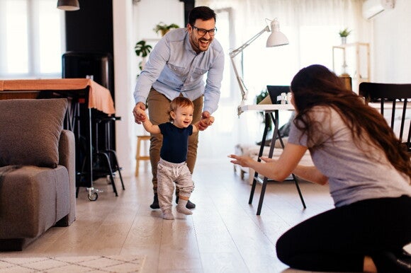 It is important to celebrate each milestone in your baby’s first steps Parents celebrating their baby’s first steps.