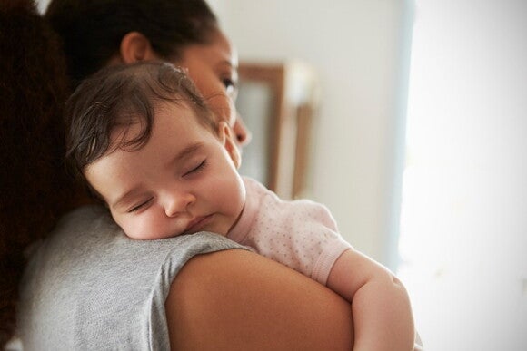 It’s important for a child to learn how to self-sooth to have a better baby sleep A child enjoying baby sleep in their mother arms