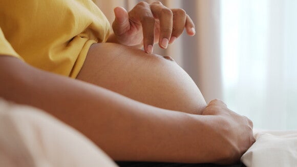 A pregnant woman having Braxton Hicks contractions.