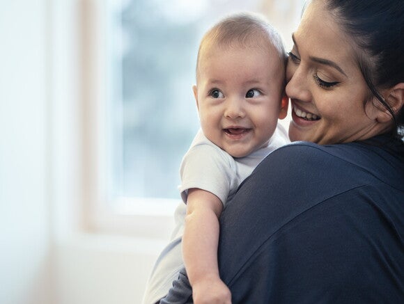 A clean breast pump is healthy for the mom and her baby. A woman holding her baby while they smile.