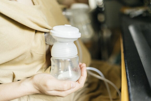 A woman using a breast pump to do some breastfeed milk storage