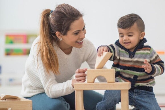To enjoy motherhood is important to have a balance between the time you spend with your child and the one you spend with yourself A mother playing with her child and enjoying motherhood.