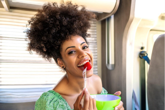 a woman taking a food rich in folic acid