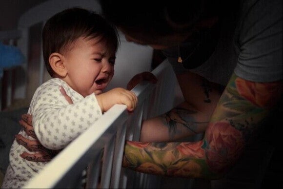 A baby with growing pains crying. 