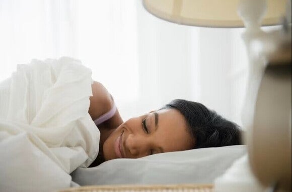 Woman sleeping placidly on her bed